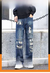 Detail view of distressed blue jeans with patchwork design and breathable denim fabric