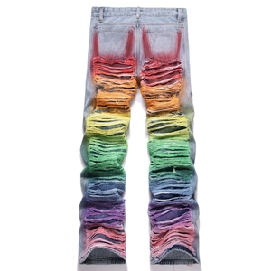 Men's relaxed straight light blue jeans with colorful rainbow spray paint and ripped details