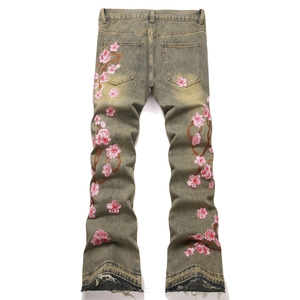 Men's washed vintage flared jeans with pink floral embroidery and frayed hems