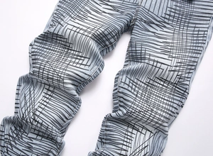 Detail of light blue slim flare jeans with black abstract graffiti and line print