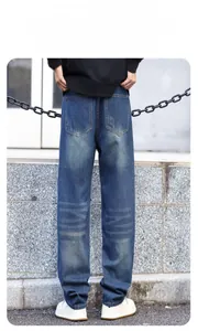 Detail of distressed deep blue denim fabric with vintage whiskers and wear-resistant texture