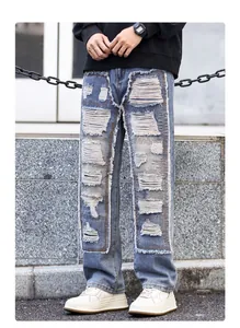 Detail of light blue distressed jeans featuring heavy patchwork and frayed ripped edges