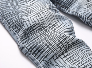 Detail of light blue denim fabric with unique black graffiti line print for streetwear style