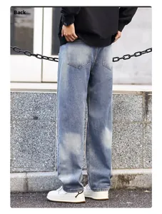 Back view of men's loose straight leg jeans in light blue washed denim with pockets