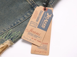 Detail of vintage denim waist with green zigzag stitching and retro leather labels