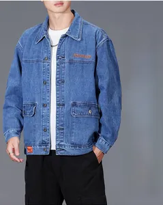 Detail of blue denim jacket showing orange Waveakear embroidery and chest flap pockets