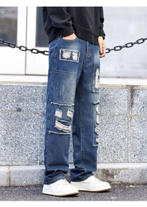 Detail showing distressed patchwork and heavy stitching on dark blue vintage jeans