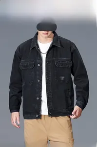 Detail of black denim utility jacket featuring chest pockets and fashion letter print