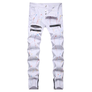 Slim fit white jeans with colorful paint splatter, decorative zippers, and button fly detail