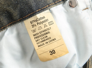 Detailed laundry label showing 97% cotton and 3% polyester material for denim jeans
