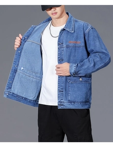 Detail of dark blue denim jacket featuring orange WAVEAKEAR embroidery and classic collar