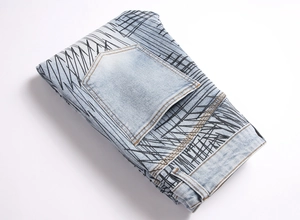 Detail of light blue denim with black graphic print and back pocket stitching detail