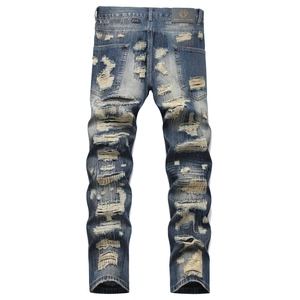 Mens slim fit distressed denim jeans in vintage blue wash with patched holes and repair details