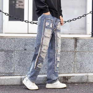 Men's street fashion light blue distressed jeans with rectangular patchwork and raw edges
