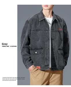 Detail of grey denim jacket collar with metal buttons and red embroidered letter accent