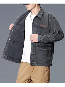 Detail of red Wayfakear embroidery and flap pockets on dark gray denim jacket