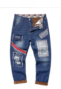 Detail view of men's distressed jeans featuring brown fleece lining and Lover embroidery