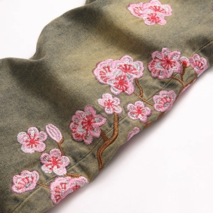 Slim fit retro denim flare pants featuring intricate plum blossom floral embroidery detail