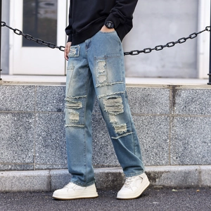 Men's light blue distressed jeans with patchwork and heavy destroyed street style details