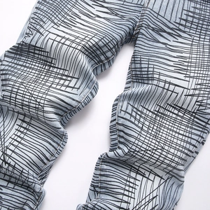 Slim fit light blue denim flared jeans with all-over black hand-drawn graffiti line pattern