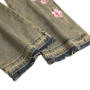Men's retro slim flare jeans featuring vintage wash and pink cherry blossom embroidery