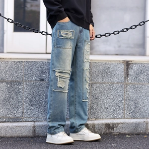 Vintage light blue distressed jeans for men with patchwork details and ripped elements