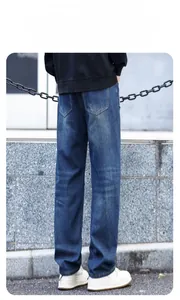 Rear view of loose fit dark blue denim jeans showing back pocket and whiskering detail