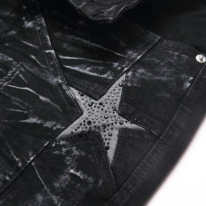 Slim fit black washed flared jeans featuring a large rhinestone-studded star patch detail