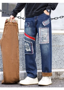 Detail showing thick brown polar fleece lining inside blue distressed men's denim jeans
