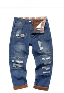 Detail view of men's distressed jeans featuring patch designs and warm fleece lining