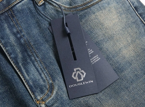 Close-up of blue denim jeans with yellow stitching and vintage washed texture detail