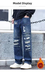 Detail of loose-fit distressed jeans for men with warm fleece lining and patch designs