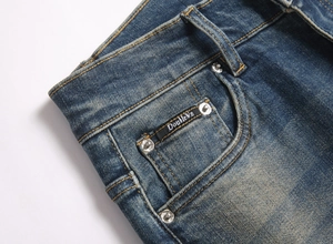 Macro shot of men's blue jeans featuring washed denim texture and DoubleWn brand tag