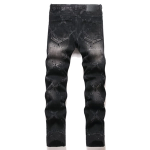 Slim fit black denim pants featuring heavy-wash texture and all-over cross pattern embroidery