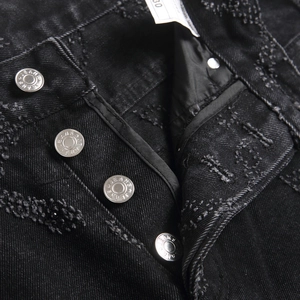 Slim fit black denim jeans for men with heavy metal buttons and intricate embroidery texture
