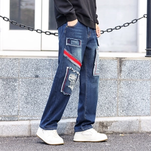 Men's baggy distressed blue jeans with patch design and red-white stripes streetwear style