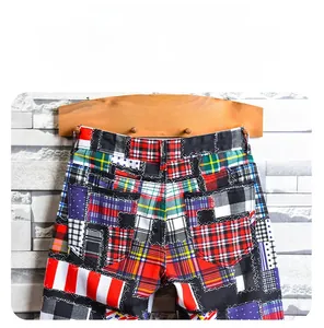 Detail view of colorful patchwork pattern and rear pockets on men's plaid denim shorts
