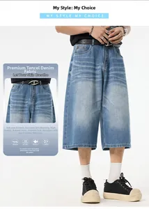 Detail of light wash tencel denim shorts with black leather belt and D-ring buckle