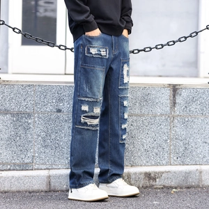 Men's loose straight-leg distressed jeans in dark blue denim with patch details