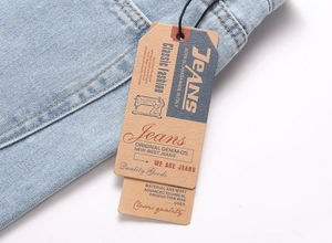 Detailed close-up of light blue flared jeans waistband with vintage denim paper tags