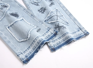 Close-up of street style blue flare jeans with star patches and distressed frayed hems