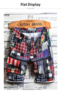 Detail shot of men's denim shorts with colorful plaid and polka dot patchwork pattern