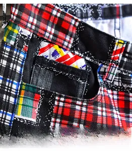 Detailed close-up showing the front pocket and stitching of plaid casual denim shorts