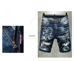 Close-up of slim-fit denim shorts featuring colorful paint splatters and distressed details