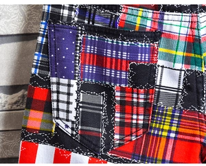 Detail of plaid patchwork pockets and star patterns on street style denim shorts