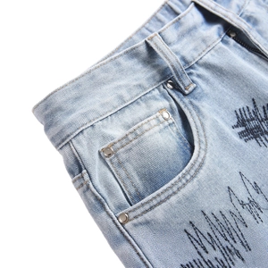 Men's punk style light blue flared jeans featuring unique black abstract wave embroidery