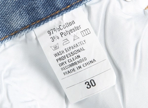 Gros plan de l'étiquette d'entretien du jean montrant 97% coton et 3% polyester pour la composition