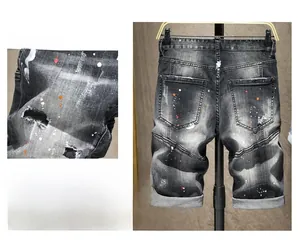 Dettaglio degli shorts in denim strappati con etichetta in pelle rossa e schizzi di vernice