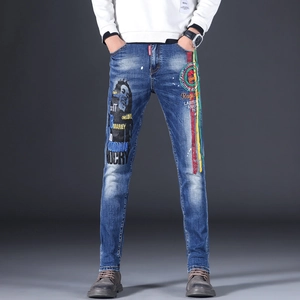 Detail of Bob Marley portrait and One Love lyrics on blue slim fit denim jeans