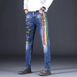 Slim fit blue washed jeans featuring Bob Marley graphic prints and street style embroidery